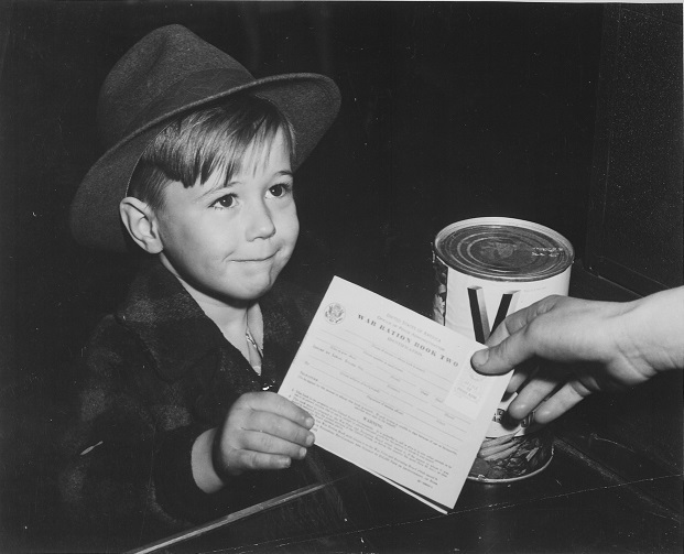 A young school boy using a War Ration Book 8″x 10″ World War II Photo #201