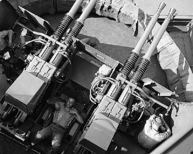 Sailor asleep between 40mm guns on board the USS New Jersey 8x10 WWII Photo 529a